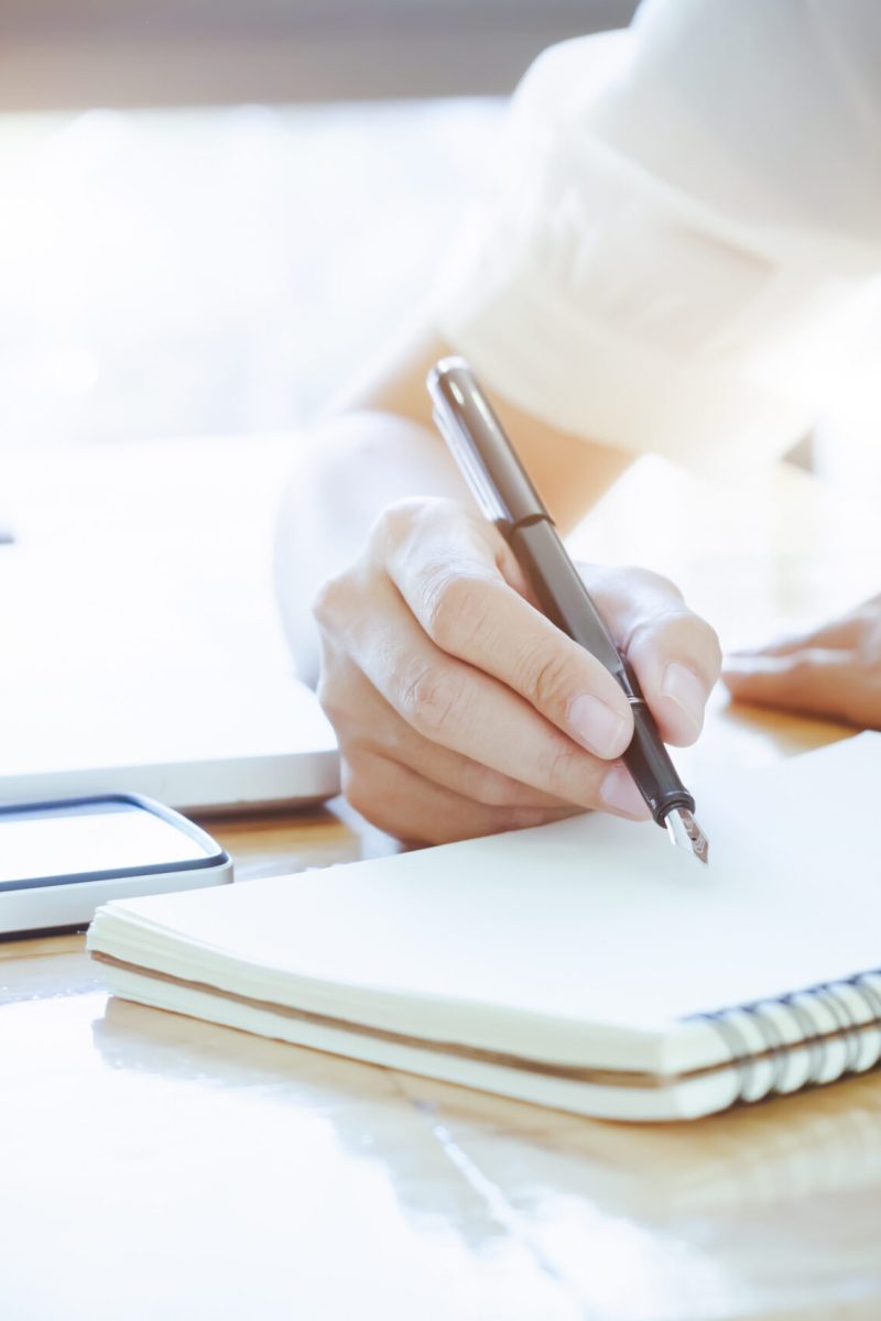 vecteezy_a-close-up-view-of-a-woman-writing-notes-in-a-notebook_1269549